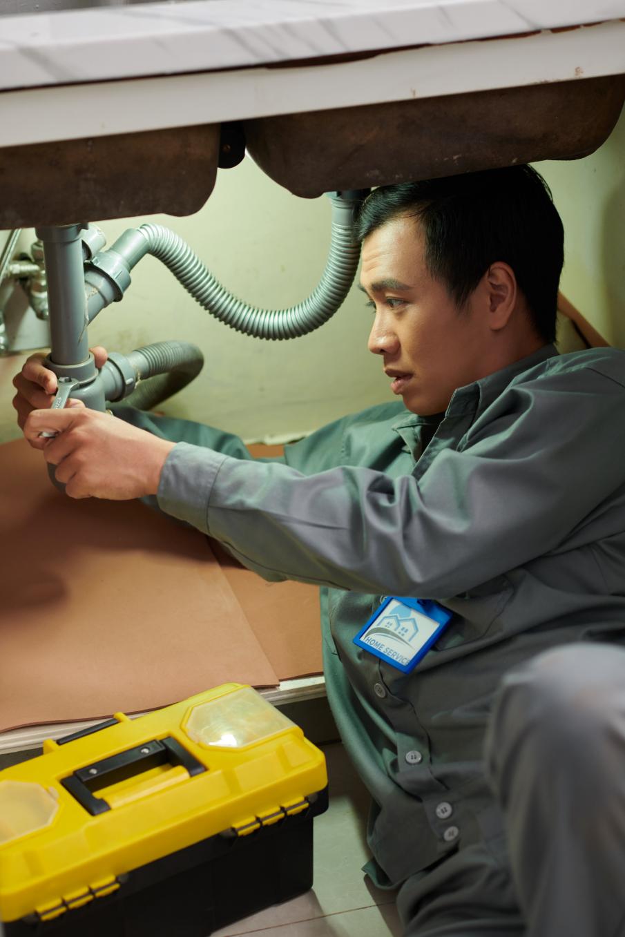 Plumber working on pipe connections